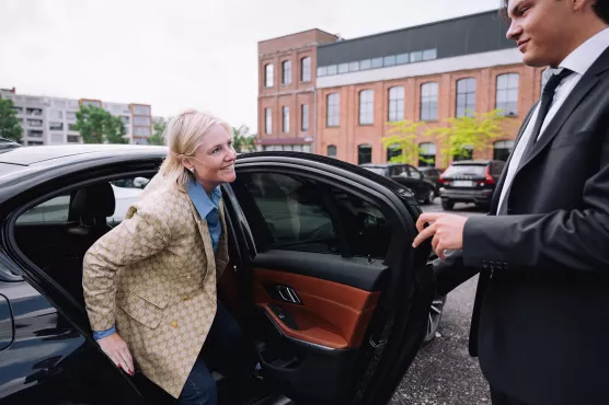Chauffeur opening the door for client